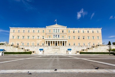 the greek parliament and the monument of the unknown soldier with guards in athens,greece 