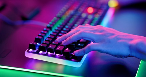 close up of pro cyber sport gamer play game with rgb keyboard 