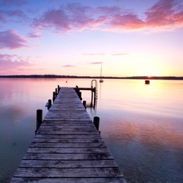 a long pier leading out onto the sea, sunrise on sea, long way out 