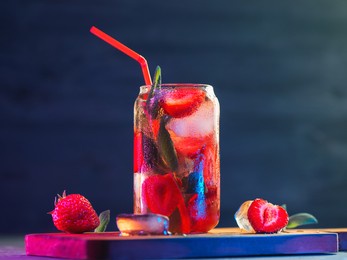 refreshing strawberry mojito in a glass with a straw, close-up, neon light