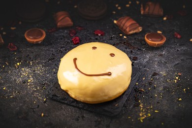 tasty smile face doughnut or donut on black slate background