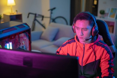 young asian handsome pro gamer playing online cyber sport game at home