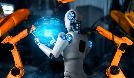 mechanized industry robot and robotic arms for assembly in factory production . concept of artificial intelligence for industrial revolution and automation manufacturing process .