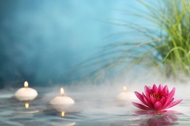 burning candles and water lily in a serenity pool