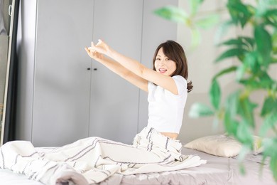 young woman waking up in the morning sun