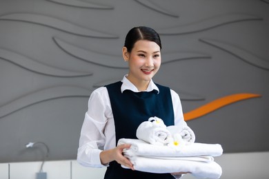 housekeeper or maid cleaning hotel room. asian woman worker working in hotel and resort.