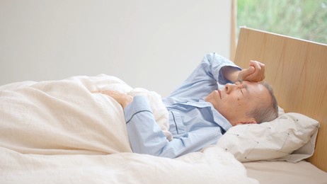 senior asian man sleeping on the bed