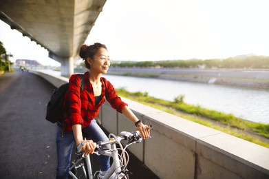 asian woman riding a bicycle