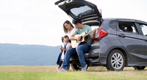 asian family.happy little girl with family sitting in the car.car insurance concept