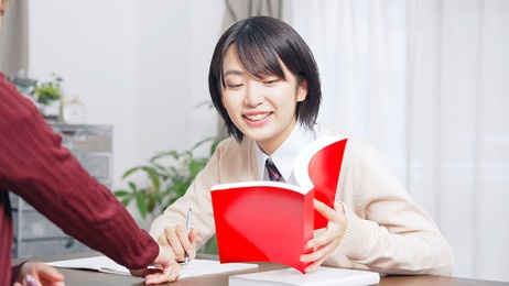 asian female high school student and teacher in classroom. cram school. preparatory school. home tutor.