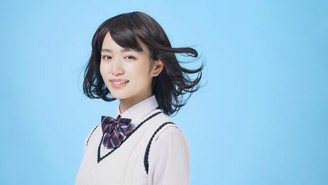 young asian school girl blowing her hair.