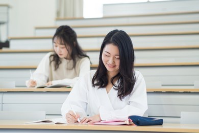 university students taking lectures in the lecture room