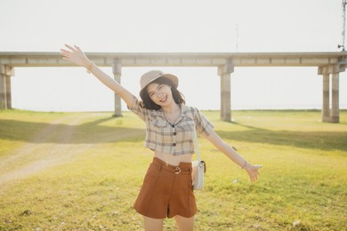 asian women tourist with relaxing mood and watching beautiful view of mountain, blue sky and clouds. young woman traveling alone in summer. asian caucasian pretty model. outdoor concept.