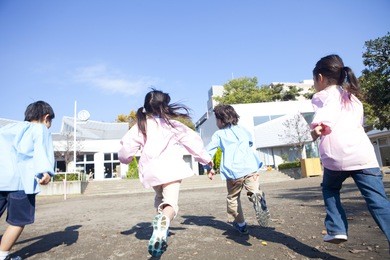 kindergarten children running in the playground