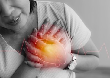 woman use hand to hole on chest with pain and suffer face from heart disease with heart shape graphic design on top layer. concept of st elevated myocardial infarction.