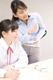 a middle school girl learning from a teacher at an institute