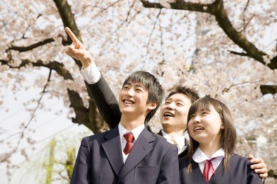 a teacher and middle school boys and girls looking up to the sky