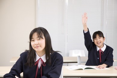 a middle school girl raising her hand
