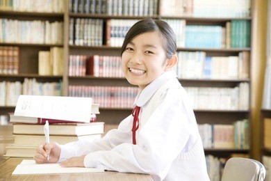 a middle school girl studying in a library