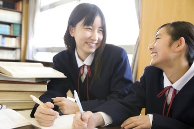 2 middle school girls studying in a library