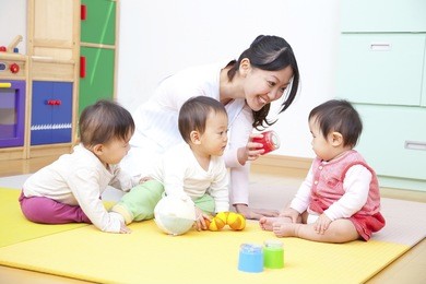 nursery school children and nursery playing with toys