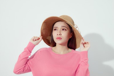 asian woman wearing fashion straw beach hat for skin care sun protection. 