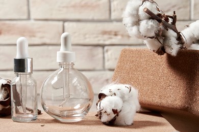empty flasks for cosmetics liquids on the decorated makeup desk. fashion and beauty backgrounds and symbols for advertisement