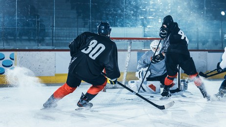 ice hockey rink arena: professional forward player attacks, shows expert stickhandling, dribbles, handling puck with hockey stick beautifully, defense unable to intercept.