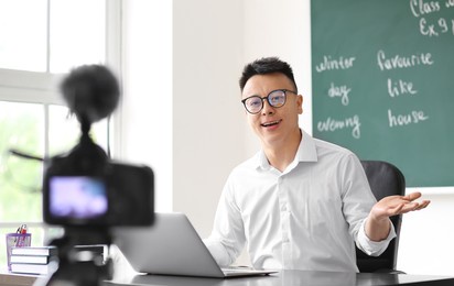 asian teacher conducting english lesson online