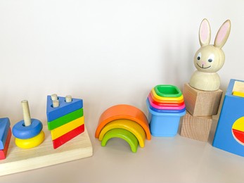 wooden toys on a light background. the concept of child development according to the montessori method. a colored rainbow. previously, the development. eco-friendly toys.