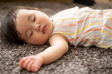 asian baby sleeping in the living room