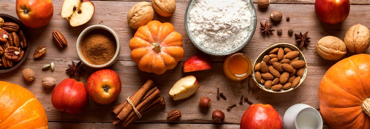autumn fall baking background with pumpkins, apples, nuts, food ingredients and seasonal spices, banner. cooking pumpkin or apple pie and cookies for thanksgiving and autumn holidays.