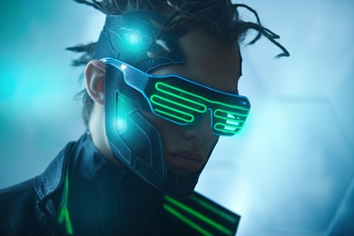 close up portrait of cyberpunk warrior of the future in green virtual reality glasses on blue digital background. game, virtual reality. future technologies.