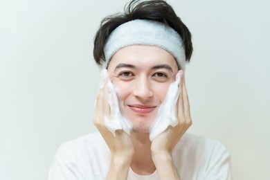 young man washing his face