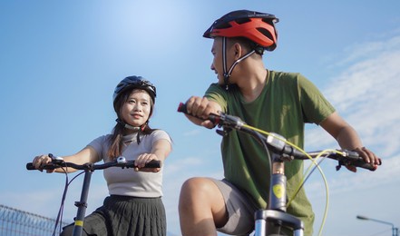 young asian couple ride bicycle in the morning