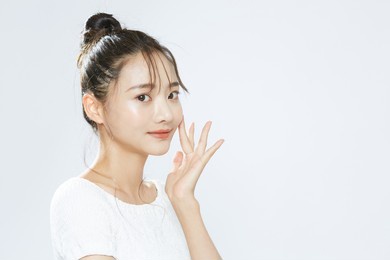 beauty portrait of a young asian woman with bun hair
