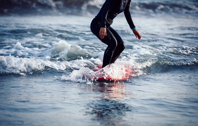 surfer woman practice surfing in the white water
