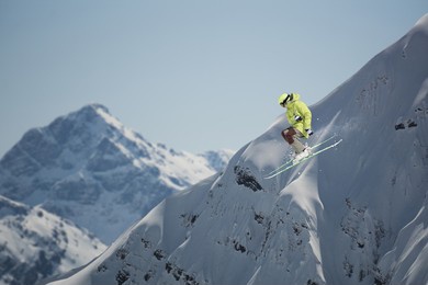 flying skier on mountains. extreme sport, mountain ski.