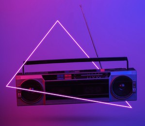 retro radio tape recorder. in blue-red neon gradient light with triangle. pop culture. 3d photo. 80s retro wave. minimalism