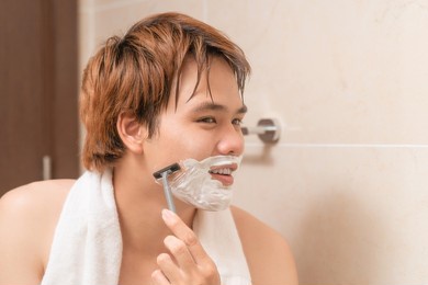 man shaving in the bathroom.