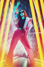 beautiful young dancer girl dancing in neon light. modern dances. disco. hi-tech dance style. 