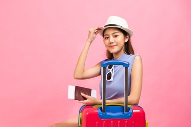 tourist young woman in summer casual clothes.asian smiling woman .passenger traveling abroad to travel on pink color background.asian woman going to summer vacation.travel trip funny.