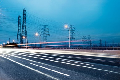 high voltage post.high-voltage tower sky background,besides the highway