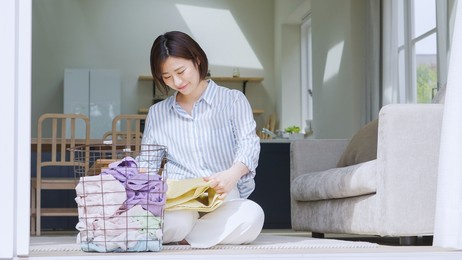 asian woman folding a towel