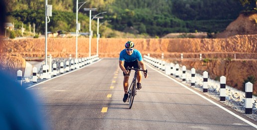 mountain biking cyclist cycling, asian man athlete carrying bike racing on highway traffic road, extreme sport wear gear uniform helmet, exciting freedom outdoor sunset nature healthy active lifestyle