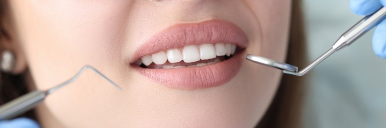 portrait of woman with white beautiful teeth at dentist appointment