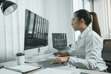 software developers are analyzing about the code written into the program on the computer in office room.