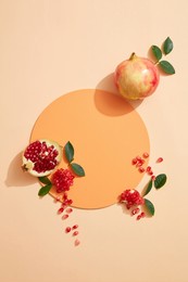 top view cosmetic background for product presentation with pomegranate extract. empty cosmetic circle podium and pomegranate extract on light orange background. flat lay