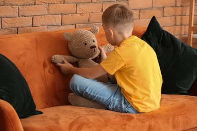 little boy with autistic disorder playing with toy at home