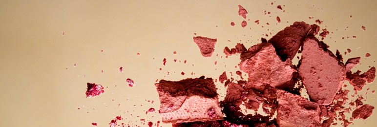 crushed cosmetics, mineral organic eyeshadow, blush and cosmetic powder isolated on golden background, makeup and beauty banner, flatlay design.